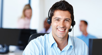 A male with a headset smiling